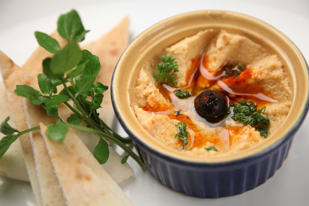 a bowl with hummus in it