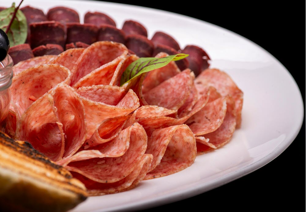 a plate of different types of salami